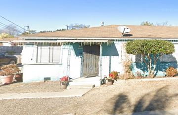 San Diego apartment for rent - A house with a blue and white exterior and a brown roof.