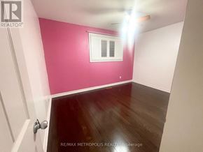 Toronto (Centennial Scarborough) house for rent - A room with a pink wall and a window.