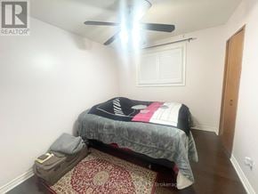 Toronto (Centennial Scarborough) house for rent - A bedroom with a bed, pillow, and a ceiling fan.