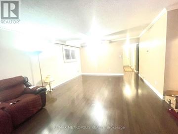 Toronto (Centennial Scarborough) house for rent - A living room with a red couch and wooden floors.