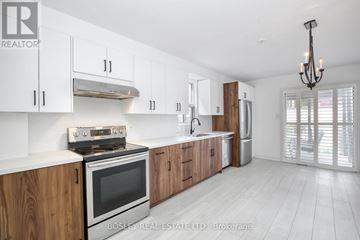 Toronto (Little Portugal) house for rent - A modern kitchen with wooden cabinets and stainless steel appliances.