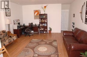 Waterloo townhouse for rent - A living room with a brown leather couch and a brown rug.
