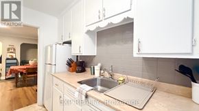 Ottawa multi-family for rent - A kitchen with white cabinets and a sink.