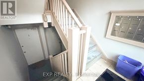 Ottawa multi-family for rent - A staircase with a railing and a wall-mounted thermostat.