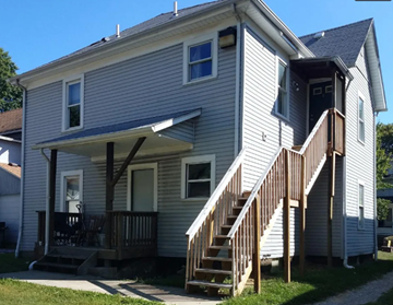 Akron apartment for rent - A house with a grey siding and a white door.