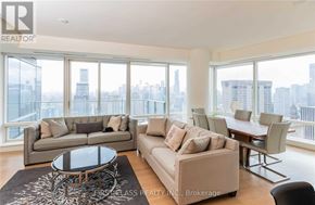 Toronto (Bay Street Corridor) condo for rent - A living room with a view of the city skyline.