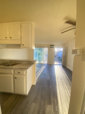 Stockton apartment for rent - A kitchen with white cabinets and a wooden floor.