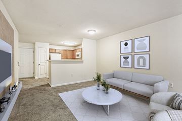 Greensboro apartment for rent - A living room with a grey couch and a white coffee table.