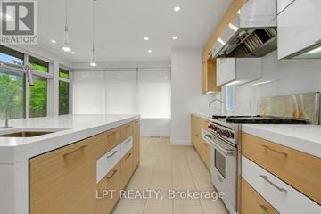 Ottawa house for rent - A modern kitchen with wooden cabinets and stainless steel appliances.