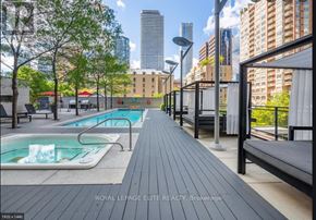 Toronto (Church-Yonge Corridor) condo for rent - A pool area with a bench and a pool with water.
