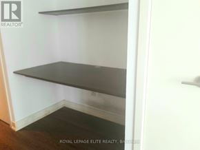 Toronto (Church-Yonge Corridor) condo for rent - Empty room with shelves and a door.
