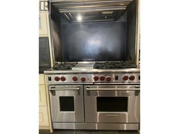 Burnaby house for rent - A stainless steel oven with the brand name HOLE is installed in a kitchen.