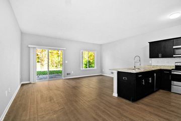 Shelby Township apartment for rent - A kitchen with black cabinets and a wooden floor.
