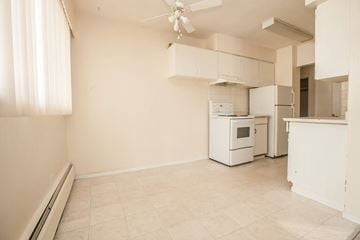 Burnaby apartment for rent - A kitchen with a white oven and a ceiling fan.