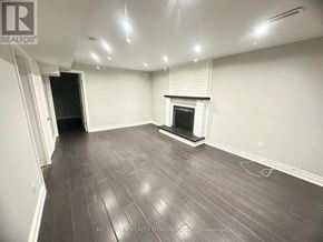 Mississauga (Creditview) house for rent - A room with a fireplace and wood flooring.