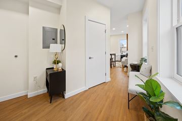 Hartford apartment for rent - A living room with a white sofa and a wooden floor.