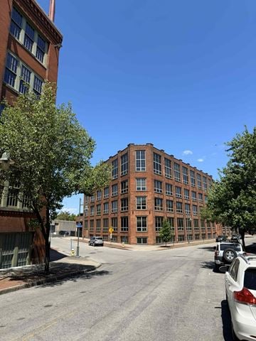 Rochester apartment for rent - A street view of a residential area with cars parked on the side of the road.