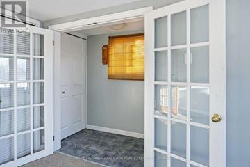 For rent in Ottawa - A living room with a black couch and a wooden coffee table.