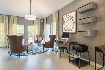 Peachtree Corners apartment for rent - A modern living room with a brown chair and a desk with a computer.
