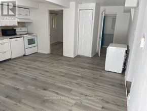 Georgina (Keswick South) duplex for rent - A kitchen with white appliances and wooden floors.