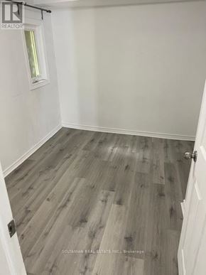 Georgina (Keswick South) duplex for rent - A room with a wooden floor and a white door.