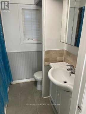 Georgina (Keswick South) duplex for rent - A bathroom with a toilet, sink, and mirror.