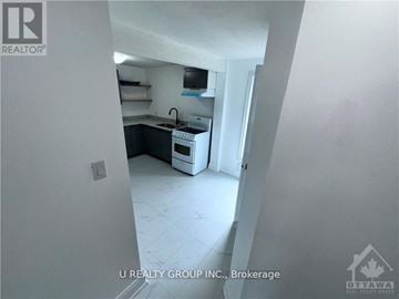Ottawa other for rent - A kitchen area with a stove top oven and a sink.