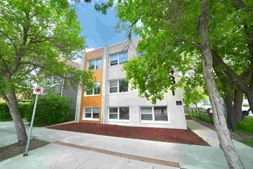 Winnipeg apartment for rent - A building with a red and white sign in front of it.