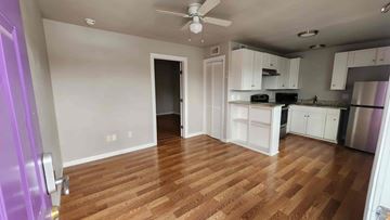 Killeen apartment for rent - A kitchen with white cabinets and a wooden floor.