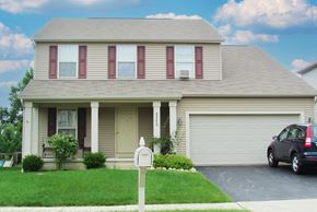 Reynoldsburg triplex for rent - a house with a car parked in front of it