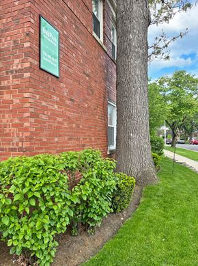 Forest Park apartment for rent - A green sign on a brick building that says "Downtown.".