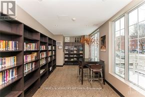 Ottawa condo for rent - A room with a large bookshelf filled with books and a table with chairs.