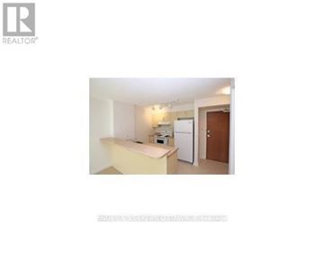 Ottawa condo for rent - A small, white kitchen with a refrigerator and a sink.