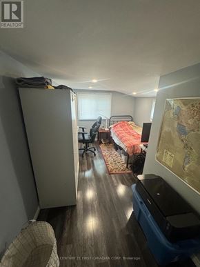 London North (North N) triplex for rent - A room with a bed, a chair, and a map on the wall.