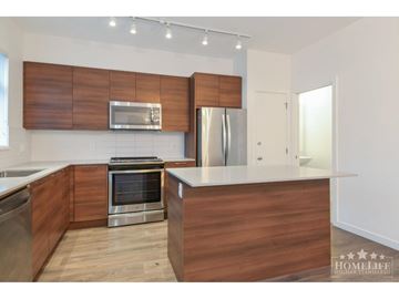 Surrey townhouse for rent - A modern kitchen with wooden cabinets and stainless steel appliances.