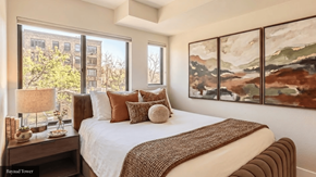 Denver apartment for rent - A bedroom with a large bed and a painting on the wall.