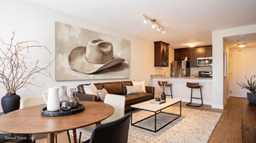 Denver apartment for rent - A cowboy hat is on a painting in a living room.