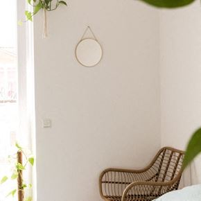 Denver apartment for rent - a bedroom with a wicker chair and a mirror on the wall