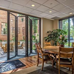 Denver apartment for rent - a dining room with a table and chairs and sliding glass doors