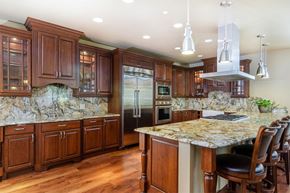 Denver apartment for rent - a large kitchen with marble counter tops and wooden cabinets