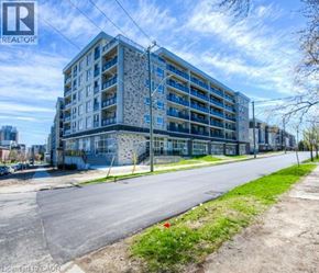 Waterloo condo for rent - A large, modern apartment building with a flat roof and multiple balconies.