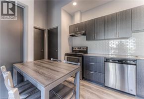 Waterloo condo for rent - A modern kitchen with a wooden table and stainless steel appliances.