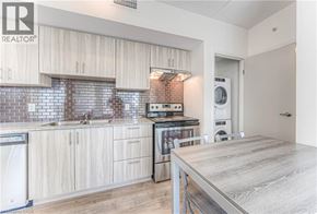Waterloo condo for rent - A modern kitchen with wooden cabinets and a washing machine.