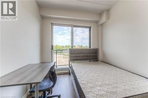 Waterloo condo for rent - A room with a table and chairs and a window overlooking a field.