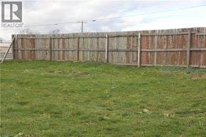 Cayuga house for rent - A grassy field with a wooden fence.
