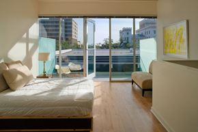 Baton Rouge apartment for rent - a bedroom with a balcony and a bed and a sliding glass door