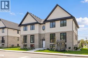Tecumseh apartment for rent - A large, modern house with a sign in front that says "Windsor-Essex County Association of REALTORS®".