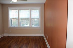 St. Louis apartment for rent - A room with a window and wooden floors.