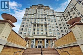 Hamilton condo for rent - A tall building with a staircase leading to the entrance.
