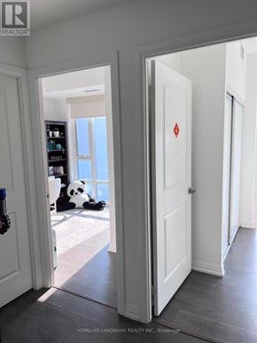Toronto (Henry Farm) condo for rent - A panda bear sitting in a room with a white door.